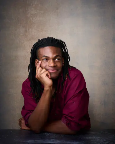 Male actor in burgundy shirt for theatrical headshot showing warm deep color choice in Phoenix studio