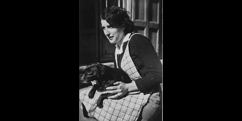 Black and white photograph by Vivian Maier of Madeleine with her dog Mirou