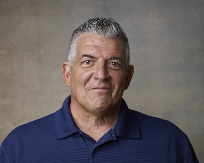 SAG actor in navy polo shirt for a coach character acting headshot in Phoenix Arizona