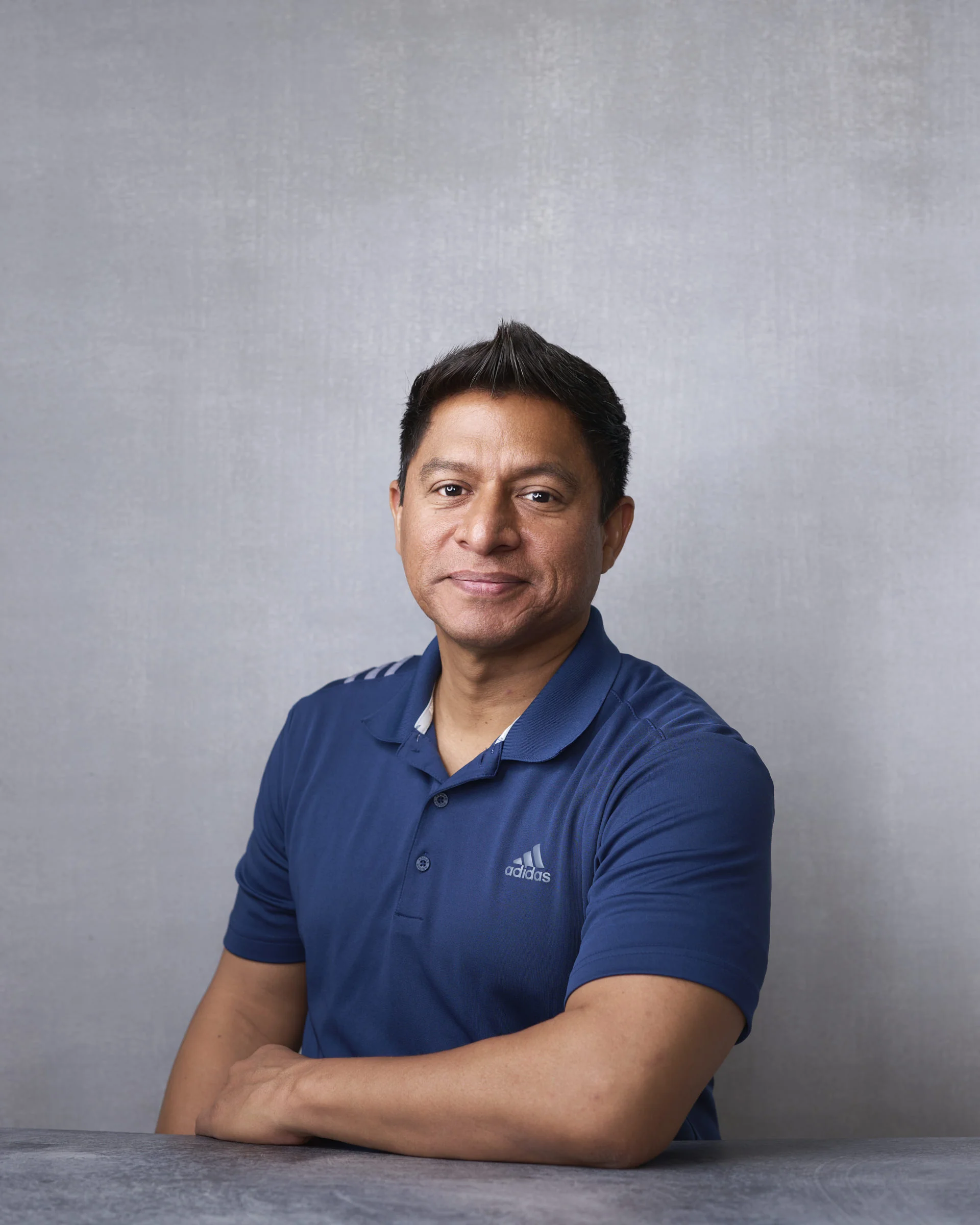 Branded polo shirt in a professional headshot — casual doesn't have to mean sloppy when the fit is right