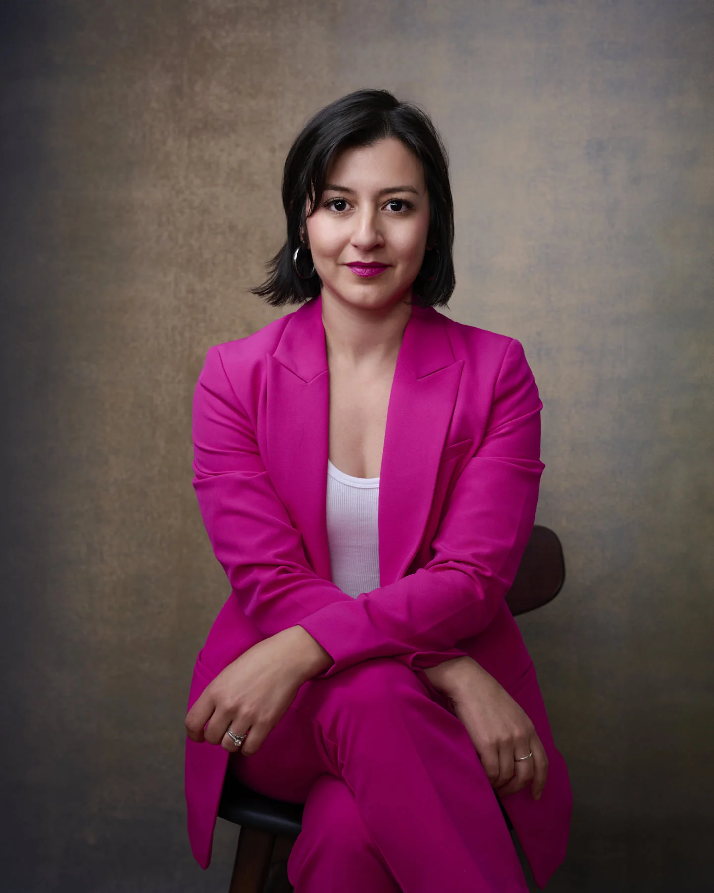Woman in bright pink for her professional headshot — bold color choices make you memorable and approachable