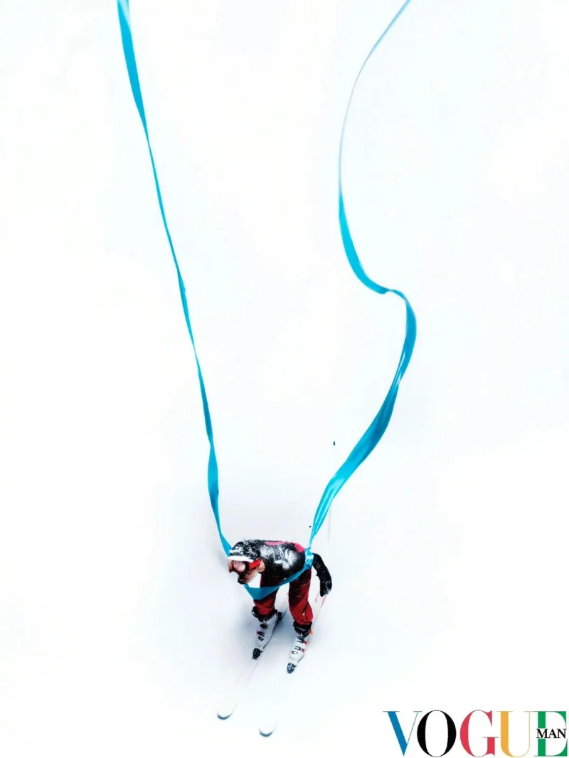 Aerial photograph of a skier trailing a flowing blue ribbon, by Win Tam for Vogue China