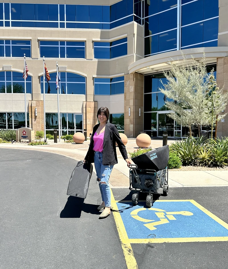 Photographer Marie Feutrier arriving at Phoenix corporate office with portable lighting equipment and backdrop bags for on-location team headshot session