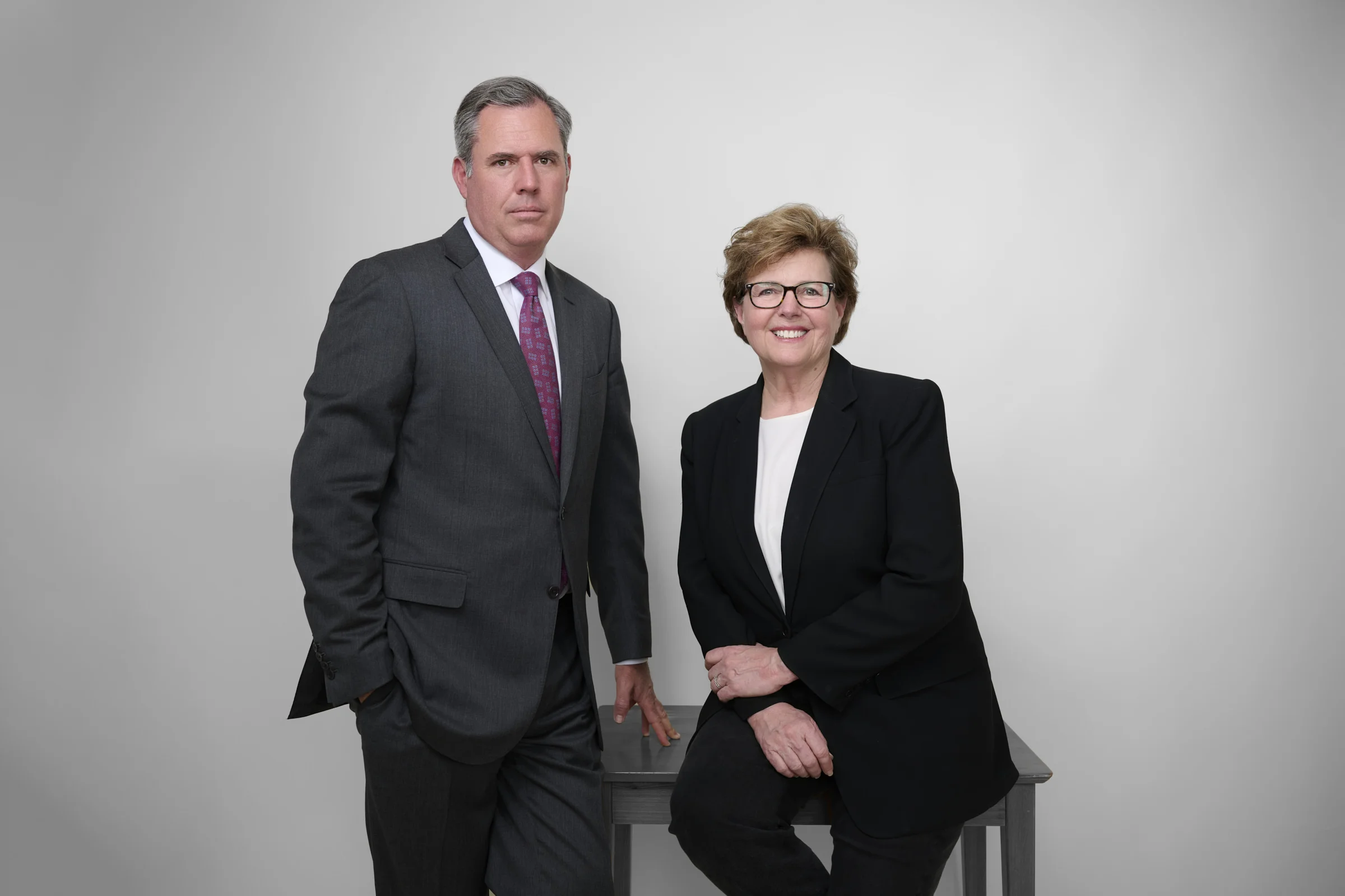 Law firm partner headshots showing contrast between serious and approachable expressions professional portrait Phoenix Arizona