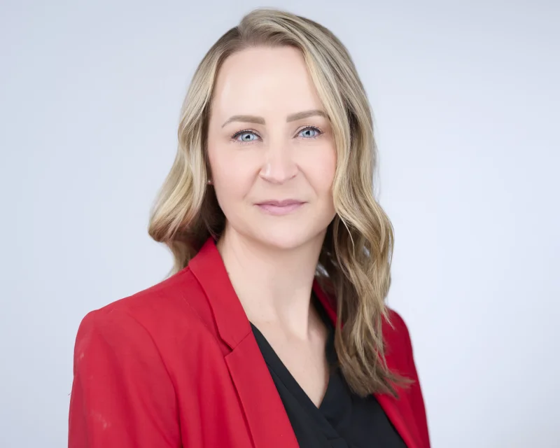 Professional woman with natural polished makeup ready for corporate headshot session